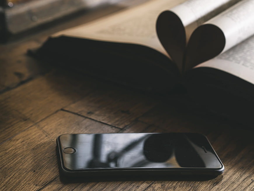 Space Gray iPhone 5s on Wooden Table with Open Book