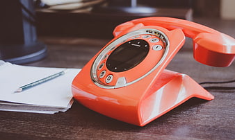 Orange Retro Cordless Phone on Wooden Desk