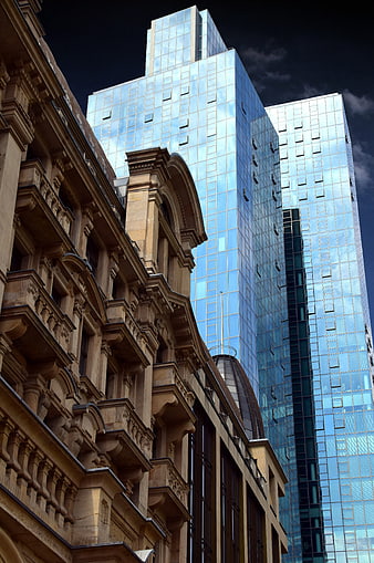 Historic Sandstone Facade Contrasting With Modern Glass Skyscrapers