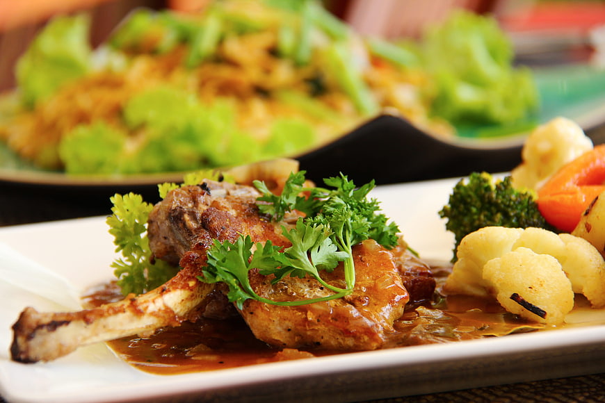 Grilled Lamb Chop with Vegetables and Sauce on White Plate