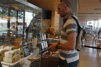 Man ordering food at a bakery counter