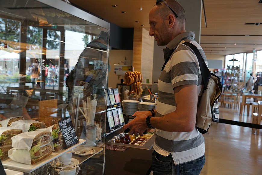 Man ordering food at a bakery counter