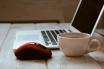 Red Mouse and Coffee Cup on Wooden Desk