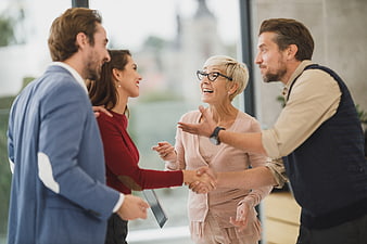 Happy Business Team Shaking Hands in Modern Office