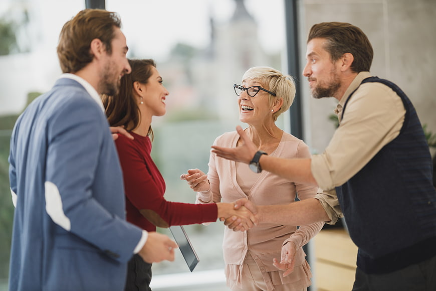 Happy Business Team Shaking Hands in Modern Office