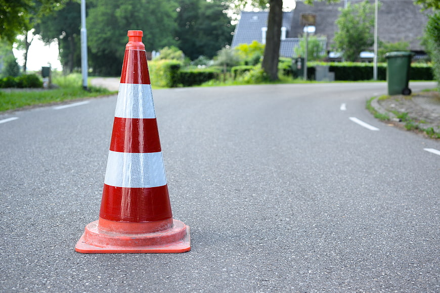 Orange Traffic Cone on Asphalt Road with Copyspace