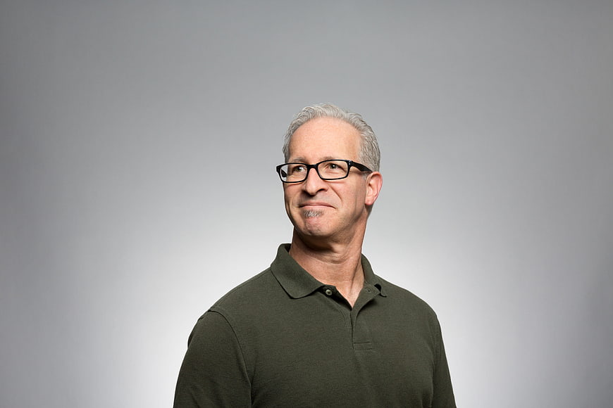 Portrait of a smiling senior man with glasses and white hair