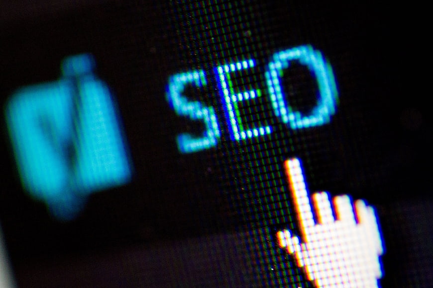 Close-up of SEO text on digital screen with cursor