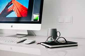 Modern minimalist home office workspace with iMac and notebook