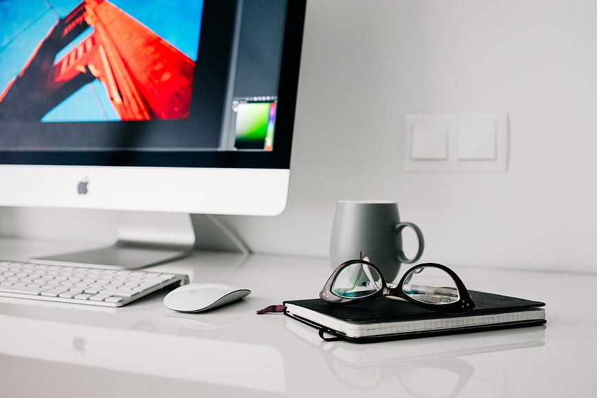 Modern minimalist home office workspace with iMac and notebook