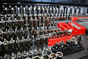 Close-up of organized socket wrench set in red and black trays