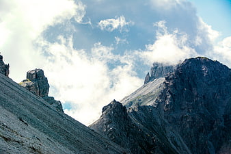 Dramatic Rocky Mountain Peaks with Clouds and Blue Sky