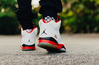 Rear View of White and Red Jordan 5 Sneakers Walking