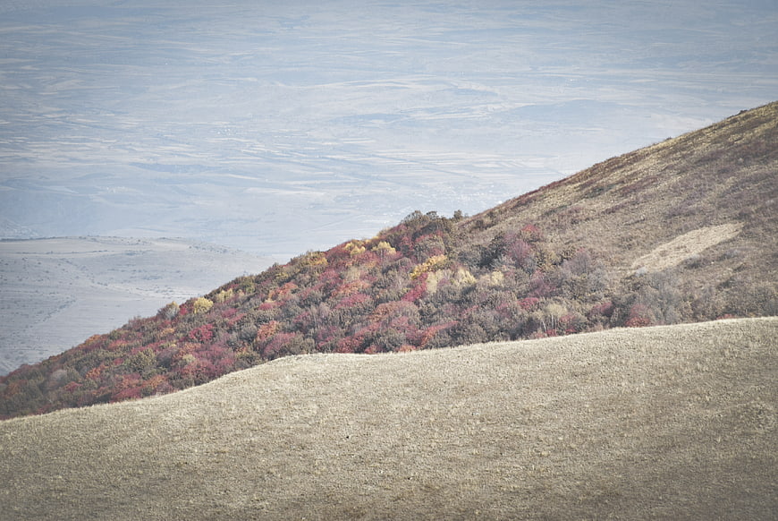 Autumn hillside landscape with colorful forest and distant valley view