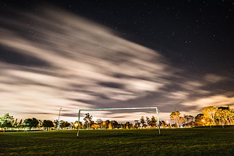 Soccer Goal Under Starry Night Sky With Streaking Clouds