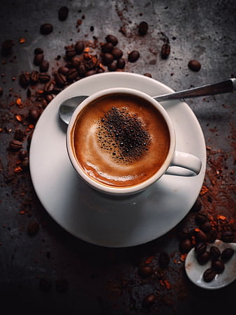 Top View of Rich Espresso with Coffee Beans on Dark Background