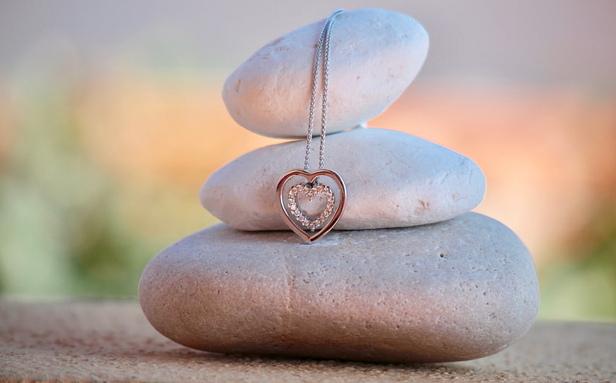 Heart pendant necklace on stacked zen stones