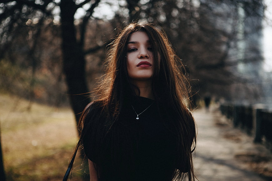 Cinematic Portrait of Young Woman in Black Outdoors