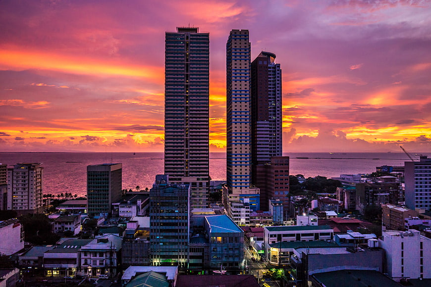 Vibrant Sunset Skyline Over Manila Bay with Skyscrapers
