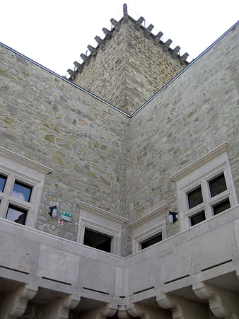 Low angle view of historic stone castle tower and courtyard