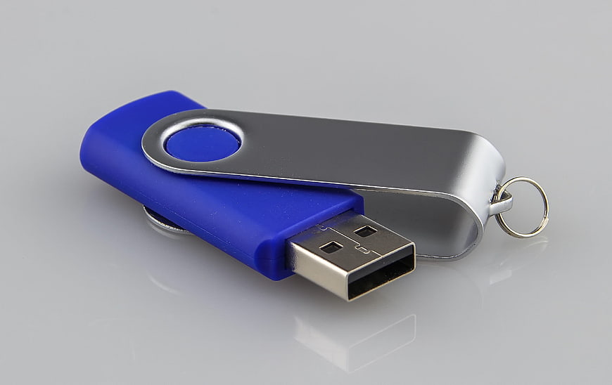 Blue and Silver Rotating USB Flash Drive on Gray Background