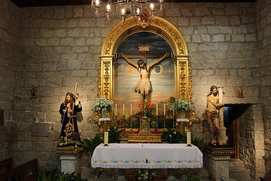 Catholic altar with crucifixion statues and golden frame