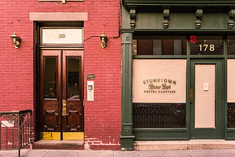 Red brick building and green Stumptown coffee shop storefront