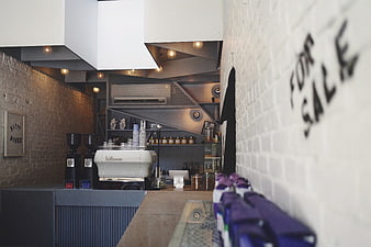 Modern Coffee Shop Interior with Espresso Machine and For Sale Sign