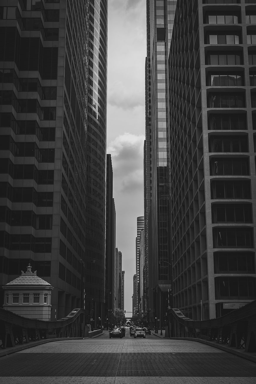 Black and white urban street view between skyscrapers