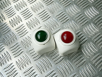 Red and Green Industrial Push Buttons on Metal Plate