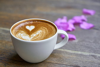 White Coffee Cup with Heart Latte Art and Purple Petals