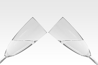 Two champagne glasses clinking on white background