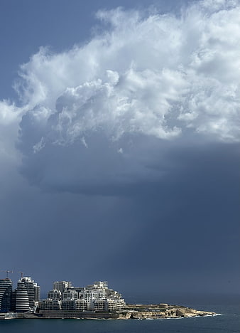 Dramatic Storm Clouds Over Coastal City Skyline