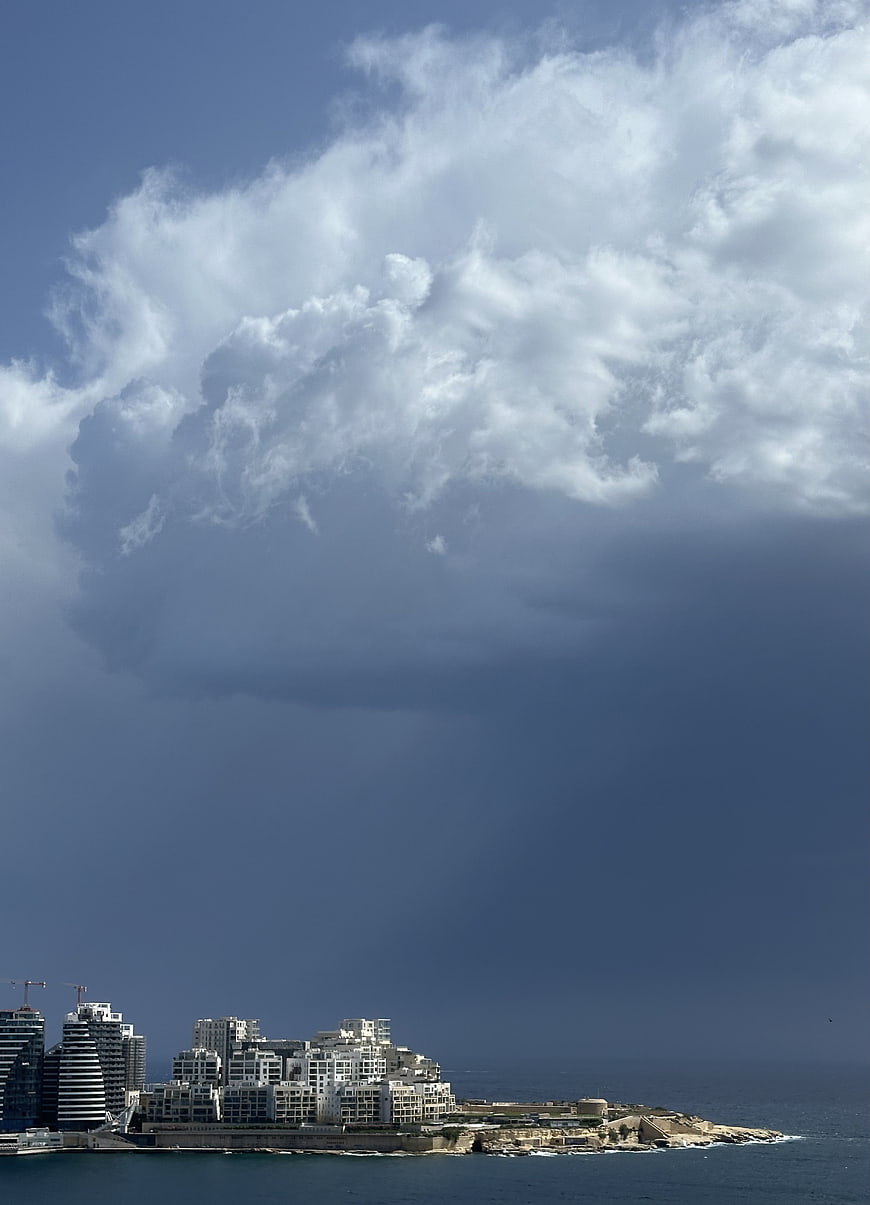 Dramatic Storm Clouds Over Coastal City Skyline