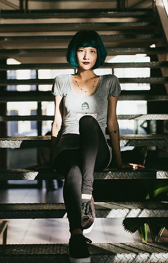 Woman with Blue Hair Sitting on Metal Stairs
