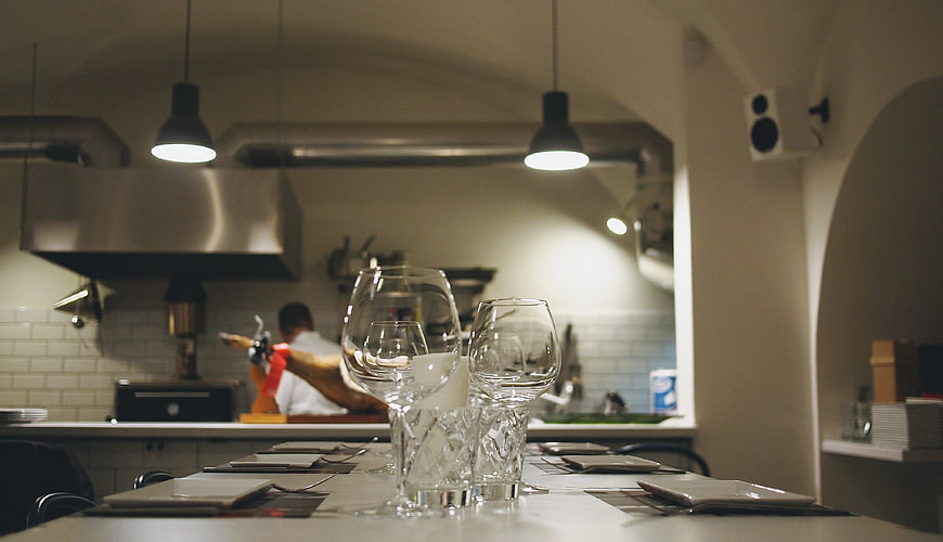 Restaurant Interior with Chef Cooking in Background