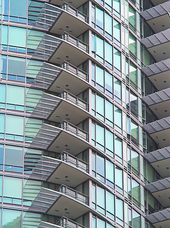 Modern Glass Building Facade with Geometric Balconies