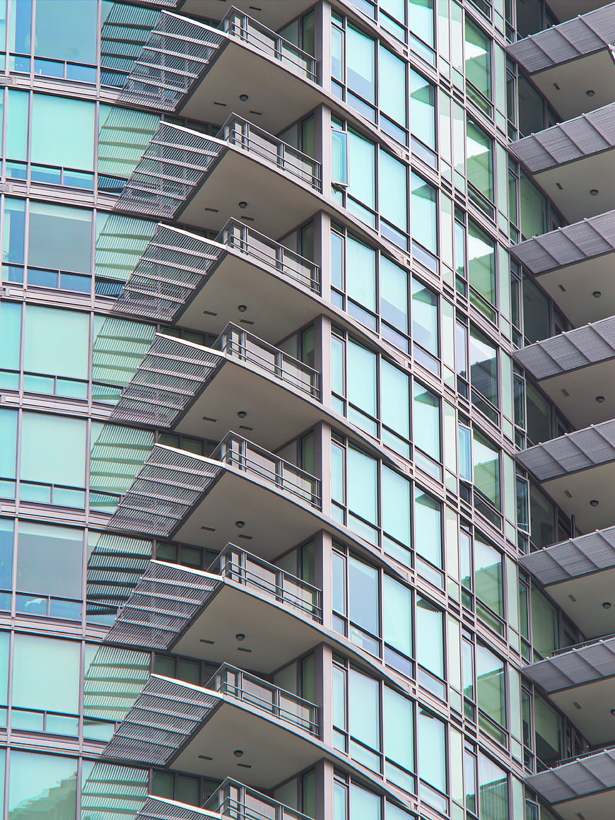 Modern Glass Building Facade with Geometric Balconies