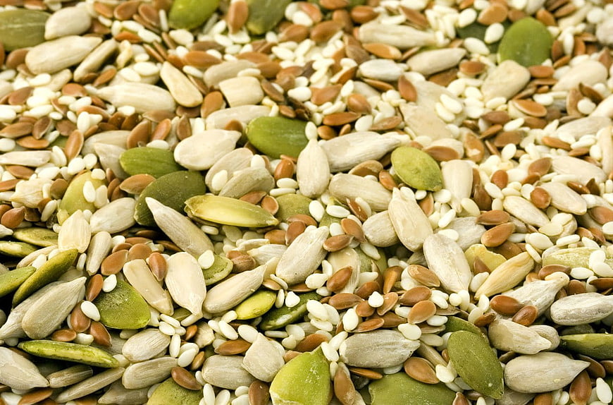 Close-up of mixed raw seeds including pumpkin, sunflower, and sesame