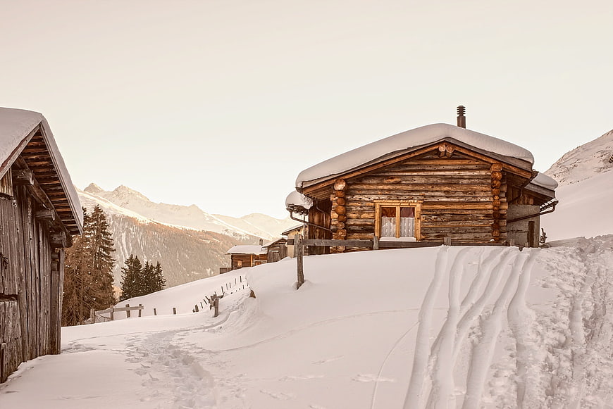 Snowy Log Cabin In Swiss Alpine Village Winter Landscape