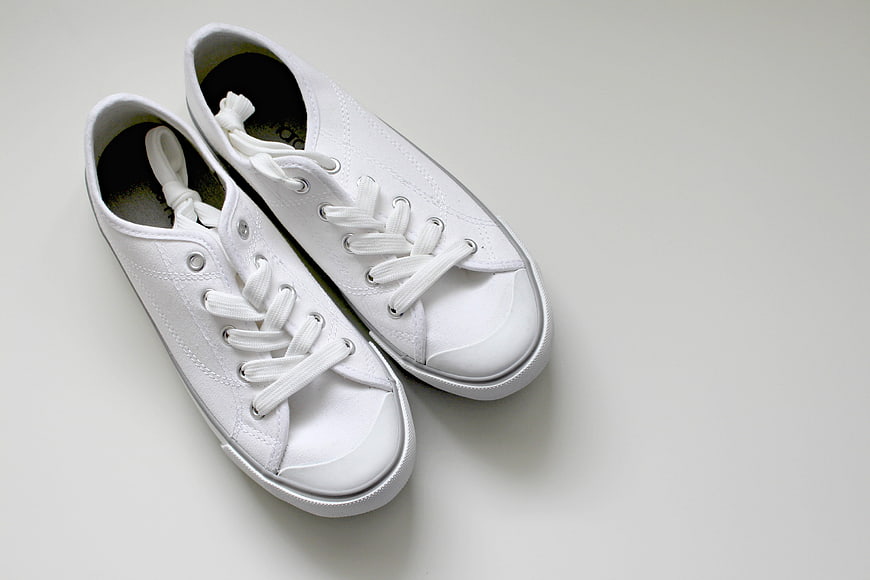 White Canvas Sneakers on Light Gray Background