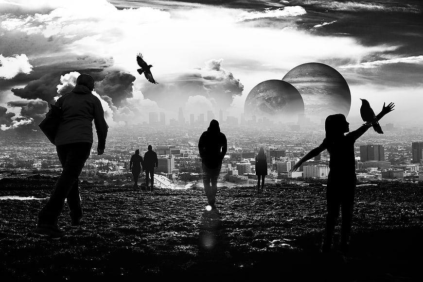 Silhouetted Figures On Hilltop With Giant Planets And City Skyline