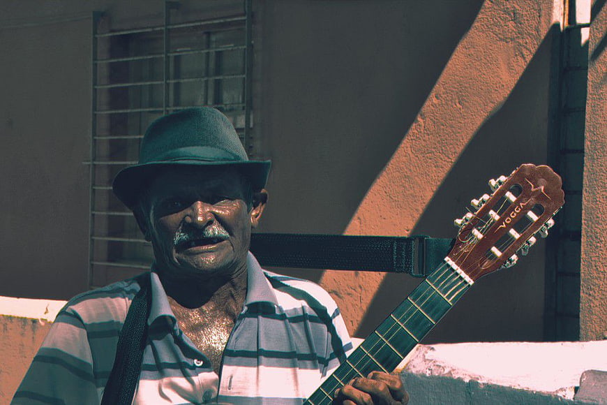 Senior Man Playing Classical Guitar Outdoors