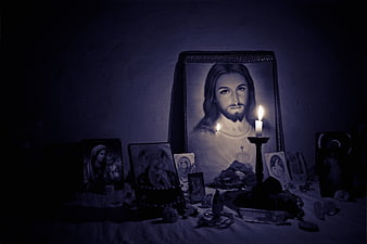 Dark religious altar with Jesus portrait and lit candles