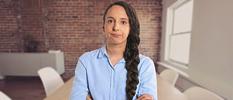 Frustrated woman with crossed arms in modern office