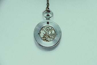 Vintage pocket watch mechanism on light blue background