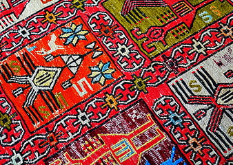 Close-up of vibrant red oriental rug with intricate geometric patterns
