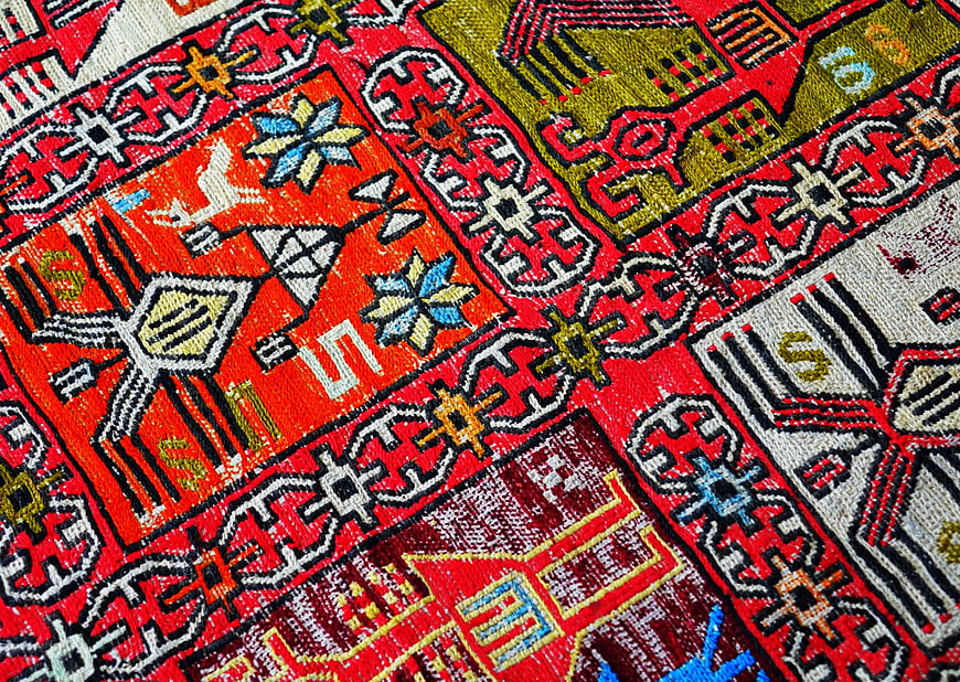 Close-up of vibrant red oriental rug with intricate geometric patterns