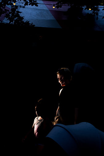 Woman and child silhouetted in dramatic low light