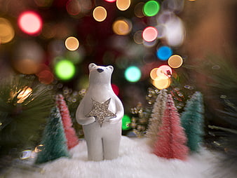 White polar bear figurine holding star with Christmas lights